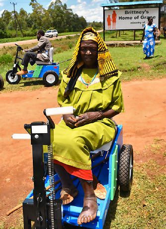 Many receive a Mobility Cart (PET) through our partner, Kenya Relief including this woman with a left foot problem and the man in the background with one leg.